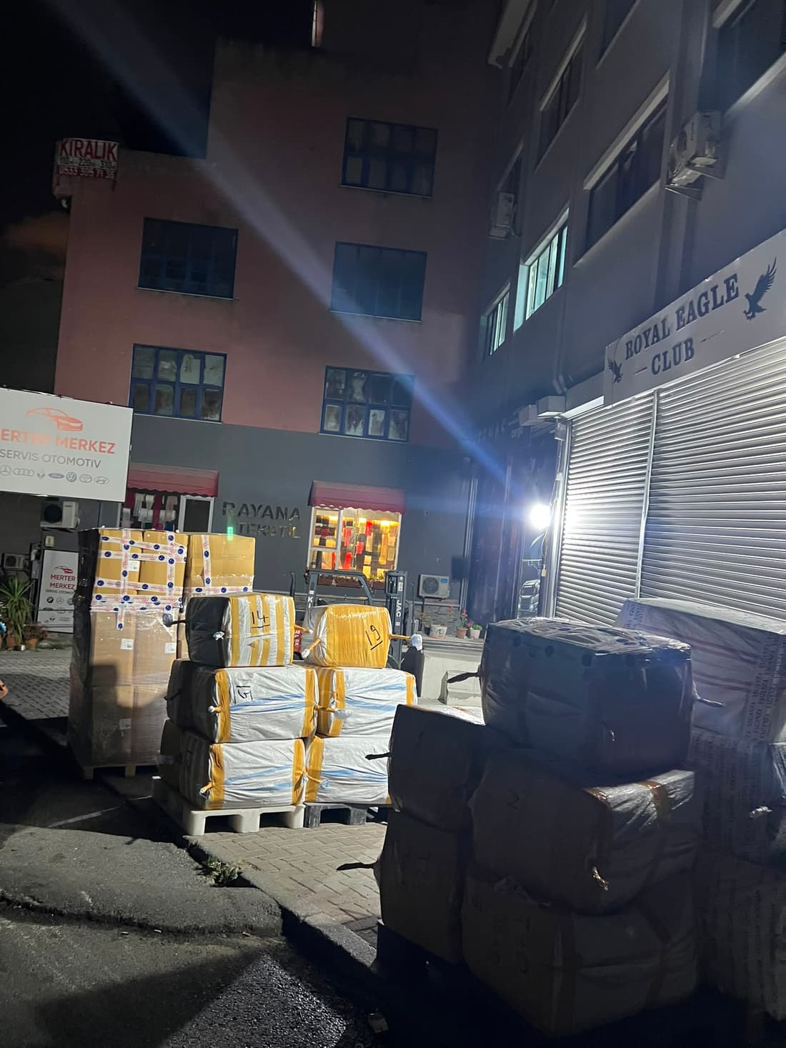 Pallets waiting on the street outside the depo at night